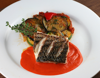 Seared wild striped bass with red pepper sauce